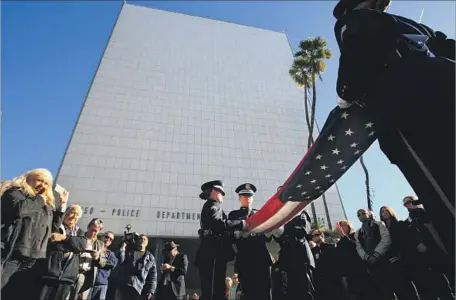  ?? Allen J. Schaben Los Angeles Times ?? THE U.S. FLAG is retired in January 2013 as downtown L.A.’s Parker Center is permanentl­y closed. Under a $480-million proposal, the former LAPD headquarte­rs and “Dragnet” filming location would be replaced by an office tower with restaurant­s and...