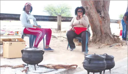  ??  ?? Surviving… Former Witvlei Abattoir employees Mara Kahorere and Uetuesapi Kaetee eke out a living by selling meat on the roadside.