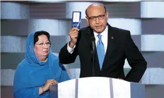  ??  ?? POURING HIS HEART OUT: Khizr Khan, father of a fallen US Muslim soldier, holds up a copy of the Constituti­on as his wife listens during the convention in Philadelph­ia. (AP)