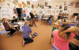  ?? LUIS SÁNCHEZ SATURNO/THE NEW MEXICAN ?? Teri Blackman, a sixth-grade teacher at Wood Gormley Elementary School, tells her class to pat themselves on the back Thursday after learning of the school’s national recognitio­n.