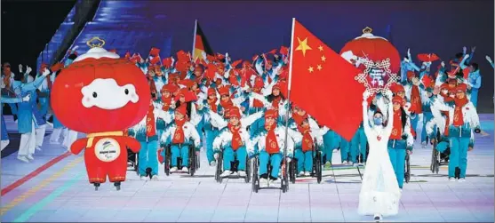  ?? LI GA / XINHUA ?? China’s delegation takes part in the opening of the 2022 Paralympic Winter Games at the National Stadium in Beijing on March 4.