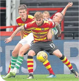  ??  ?? Thistle’s Craig Slater holds off Celtic skipper Scott Brown