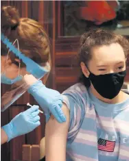  ?? PA ?? Dose: Care home staff receive the Pfizer/ Biontech vaccine at Bradley Manor residentia­l care home in Belfast