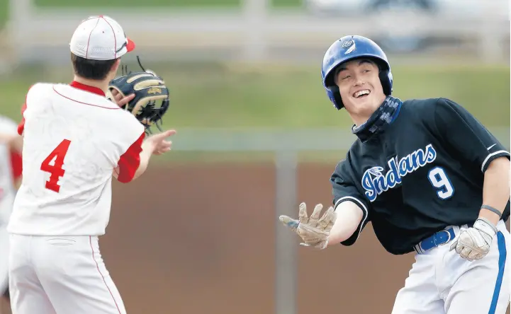  ?? JOHN SMIERCIAK/POST-TRIBUNE ?? Lake Central’s Jacob Warn, right, reacts after hitting a double during a game at Crown Point.