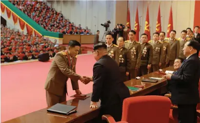  ?? AFP ?? North Korean leader Kim Jong-un awarding scientists for their success in the Hwasong-15 ICBM test launch, in Pyongyang. —