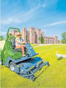  ?? Picture: Steve MacDougall. ?? Lady Mansfield mowing a lawn accompanie­d by Alexander the peacock.