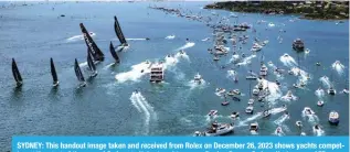  ?? — AFP ?? SYDNEY: This handout image taken and received from Rolex on December 26, 2023 shows yachts competing at the start of the annual Sydney to Hobart yacht race on Boxing Day on Sydney Harbour.