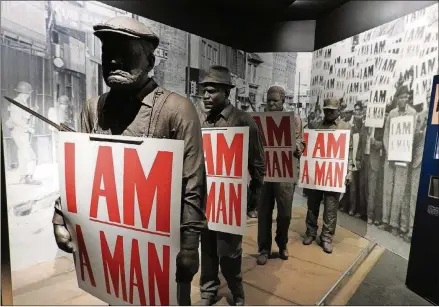  ?? JAY JONES/CHICAGO TRIBUNE/TNS ?? In a museum exhibit detailing the 1968 strike by Memphis garbagemen, models of the sanitation workers hold placards that read “I Am a Man,” the battle cry of their successful effort to organize a union.