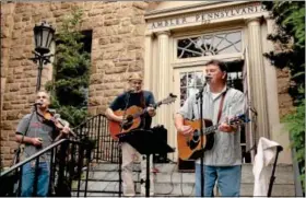  ?? Gazette staff photos by BOB RAINES ?? The McKendry Brothers entertain on the steps of the Ambler Borough building.