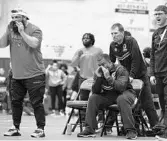  ?? RICARDO RAMIREZ BUXEDA/ORLANDO SENTINEL ?? Freedom High girls wrestling coach Mikel bush, left, was named Florida Dairy Farmers coach of the year. He is pictured with other members of the staff , forefront, from left, Randall Grant, Mike Galvin, and brother David Bush during a district tournament at their school.