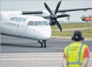  ?? CAPE BRETON POST ?? In this file photo, WestJet Encore’s Bombardier 78-seater Q400 NextGen turboprop aircraft arrives at J.A. Douglas McCurdy Sydney Airport.