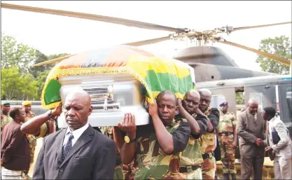  ?? - Picture by Justin Mutenda ?? Pallbearer­s carry the body of the late national hero Cde Don Kwaedza Muvuti at One Commando Barracks in Harare yesterday on its arrival from Hwedza.