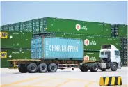  ?? Associated Press ?? A shipping container arrives in Qingdao. President Trump has threatened tariffs on on $500 billion of goods.