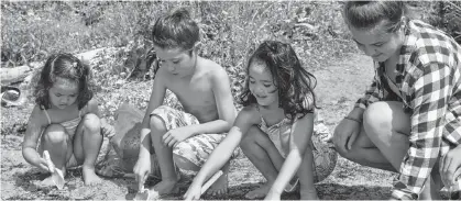  ?? DAVE STEWART/THE GUARDIAN ?? When the weather gets really hot it’s simply time to head to the beach. From left, Makoto Wells, 5, Hikaru Wells, 9, Megumi Wells, 7, and Georgia Marriman, 17, spent some time this past week digging in the sand at the Tea Hill Provincial Park.