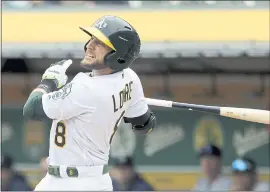  ?? MARCIO JOSE SANCHEZ – THE ASSOCIATED PRESS ?? The A’s Jed Lowrie drives in a run with a sacrifice fly during the first inning of Thursday’s game against Seattle at the Coliseum.