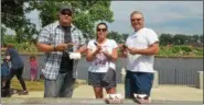  ?? NICHOLAS BUONANNO — NBUONANNO@TROYRECORD.COM ?? People enjoy some food at the 11th annual Troy Pig Out event Saturday. From left: Jon Renda of Albany, Heather Mihocko of Averill Park and Craig Jasenski of Averill Park.