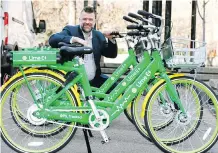  ?? DARREN MAKOWICHUK ?? Scott Harvey, operations manager for Lime, with his company’s electric pedal assist bikes at the Olympic Plaza on Tuesday.