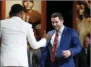  ?? TODD J. VAN EMST — THE ASSOCIATED PRESS ?? Oklahoma quarterbac­k Baker Mayfield, right, is congratula­ted by Louisville’s Lamar Jackson after being announced as thw Heisman Trophy winner in New York on Saturday.