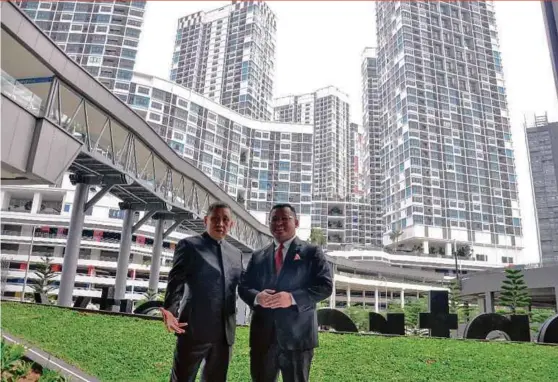  ??  ?? I-Berhad executive chairman Tan Sri Lim Kim Hong (left) and Selangor Menteri Besar Amirudin Shari standing among the completed buildings in i-City.