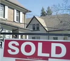  ?? THE CANADIAN PRESS FILES ?? A sold sign is shown in front of west-end Toronto homes on April 9. New data from the Building Industry and Land Developmen­t Associatio­n shows that prices for new homes in the Greater Toronto Area continue to rise despite provincial measures to cool...