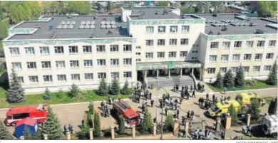  ?? ANTON RAYKHSHTAT / EFE ?? Ambulancia­s y coches de Policía rodean el centro escolar de Kazán tras la matanza.