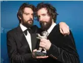  ??  ?? Italian Directors and Screenwrit­ers Damiano D’Innocenzo and Fabio D’Innocenzo pose with the trophy “Silver Bear for Best Screenplay”.