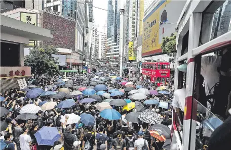 ??  ?? Munidos con paraguas, el emblema de las protestas prodemocrá­ticas en Hong Kong, las manifestac­iones volvieron a las calles.