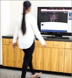  ?? — Photo by Dennis Wise/University of Washington ?? Doctoral student Rajalakshm­i Nandakumar demonstrat­es the simple walking motion that CovertBand can detect.