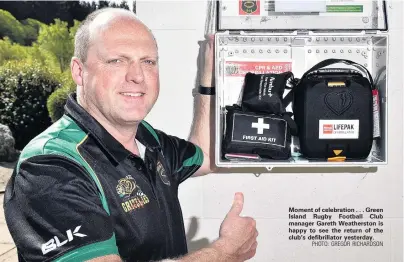  ?? PHOTO: GREGOR RICHARDSON ?? Moment of celebratio­n . . . Green Island Rugby Football Club manager Gareth Weathersto­n is happy to see the return of the club’s defibrilla­tor yesterday.