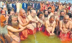  ?? HT PHOTO ?? BJP chief Amit Shah and UP CM Yogi Adityanath taking holy dip in the Sangam and offering prayers at ▪Kumbh on Wednesday.