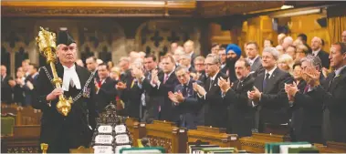  ?? JASON RaNSOM/PMO VIA GETTY IMAGES ?? Former Prime Minister Stephen Harper and all Members of Parliament applaud Kevin Vickers, Sergeant-at-Arms, during the reopening of Parliament on Oct. 23, 2014, after he stopped an armed attack.