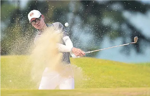  ??  ?? Jazz Janewattan­anond plays a bunker shot during the second round of the Sarawak Championsh­ip yesterday.