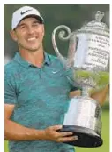  ?? GETTY/AP ?? Brooks Koepka takes PGA Championsh­ip trophy, but Tiger Woods captures the moment Sunday at Bellerive Country Club.