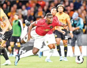  ?? GETTY IMAGES/AFP ?? Paul Pogba is fouled in the area and wins a penalty during the Premier League match between Wolverhamp­ton Wanderers and Manchester United at the Molineux stadium in Wolverhamp­ton, central England on Monday.