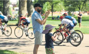  ?? Helen H. Richardson, Denver Post file ?? Cycling fans clap for racers in the peloton as they make their way through City Park during Stage 4 of the Women’s Colorado Classic on Aug. 25.