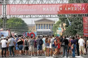  ?? ASSOCIATED PRESS ?? In this file photo, people line up to enter the “Made In America” music festival on the Benjamin Franklin Parkway in Philadelph­ia. Road closures start going into effect today the Labor Day weekend extravagan­za. for