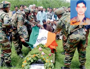  ??  ?? Army personnel pay tribute to the slain army officer Lt. Ummer Fayyaz during his funeral at his native village Sudsona in Kulgam district on Wednesday. — PTI