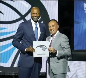  ?? CHARLES REX ARBOGAST - THE ASSOCIATED PRESS ?? Orlando Magic head coach Jamahl Mosley, left, stands with NBA Deputy Commission­er Mark Tatum after Tatum announced that the Magic have won the first pick in the 2022 NBA draft during the NBA basketball draft lottery Tuesday, May 17, 2022, in Chicago.