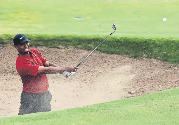  ?? Picture: Getty Images. ?? Tiger Woods plays his second shot from the bunker on the eighth hole.