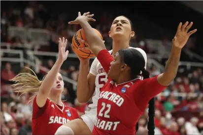  ?? PHOTOS BY KARL MONDON — BAY AREA NEWS GROUP ?? Stanford's Lauren Betts (51) drives on Sacred Heart's Ciara Brannon (22) in the Women's NCAA Basketball Tournament on Friday at Maples Pavilion in Stanford.
