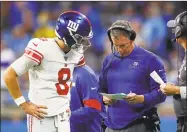  ?? Paul Sancya / Associated Press ?? Giants quarterbac­k Daniel Jones talks with coach Pat Shurmur on the sideline at Detroit in October.