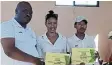  ?? Picture: SUPPLIED ?? BRIGHT STARS: President of the Junior Sundowns soccer and netball club, Khayalethu Klaas, hands certificat­es to netball player Reemanthia Van Rooyen and Club Secretary Vuyisani Maxwell Tsitsi.