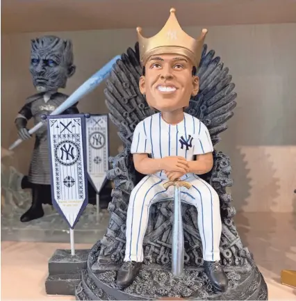  ??  ?? Yankees right fielder Aaron Judge sits on the Game of Thrones’ Iron Throne in this bobblehead.