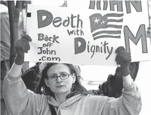  ?? AP ?? Stacey Richter protests outside a federal courthouse in Portland, Ore., in 2002 as a hearing begins to decide the fate of Oregon’s physician-assisted suicide law.