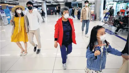  ?? REUTERS ?? People wearing masks to avoid the spread of the coronaviru­s disease (COVID-19) arrive at Gimpo internatio­nal airport in Seoul, South Korea, on May 1.