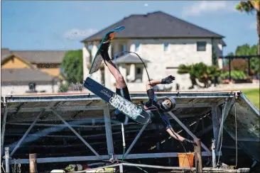  ?? TAMIR KALIFA/AMERICAN-STATESMAN PHOTOS ?? Pam LeBlanc wipes out as she attempts her first water ski jump at the Aquaplex ski lake. This is how a first-time jumper does it.