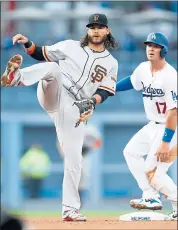  ?? DANNY MOLOSHOK — ASSOCIATED PRESS ?? Giants shortstop Brandon Crawford, left, watches as his throw to first base is too late to complete a double play after he forced out the Dodgers’ Kyle Farmer, right.