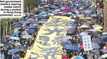  ?? REUTERS ?? Anti-government protesters wearing masks march during a protest in Hong Kong yesterday.