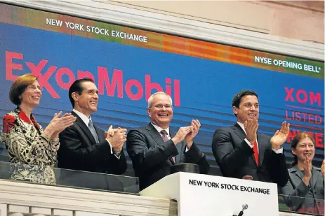  ?? /Reuters ?? At the helm: Exxon Mobil CEO Darren Woods, centre, after ringing the opening bell at the New York Stock Exchange on March 1 2017. He succeeded Rex Tillerson, who left the company to become the US’s secretary of state.