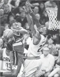  ?? (AP) ?? WASHINGTON Wizards’ John Wall, left, drives past Cleveland Cavaliers’ LeBron James for a basket during the first half of their NBA game in Cleveland Saturday.